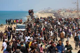 Palestinians, who were displaced by Israel's military offensive on south Gaza, make their way as they attempt to return to their homes in north Gaza.