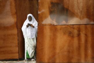 A Gambian woman puts her identity card back into her purse while exiting a polling station, in Serekunda, Gambia, on September 22, 2006.