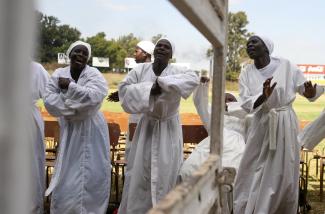Women dance during a prayer against domestic and political violence.