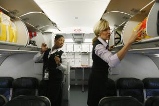 Frontier Airlines flight attendants check safety equipment