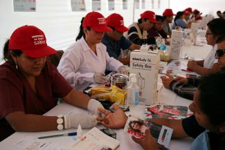 Nurses take blood for free HIV tests during a HIV prevention campaign marking the World AIDS Day.
