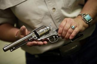 Arizona Women's Shooting Associates and National Rifle Association certified instructor Carol Ruh holds a revolver as she teaches a gun safety training class at Ben Avery Shooting Facility in Phoenix, Arizona, March 13, 2013.