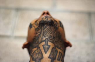 An imprisoned member of street gang Mara 18 poses for a photograph at the Izalco prison.
