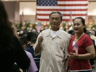 Chinese immigrants Mandy Fong, 32, and her father Ying Zong Yu, 70, have their photo taken before a naturalization ceremony, in Los Angeles, California, on September 22, 2006.