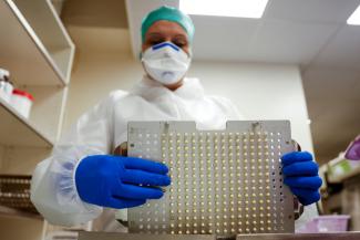 Pharmacist Stephanie Gallien prepares capsules of amoxicillin at the Delpech pharmacy, in Paris, France, on January 9, 2023.