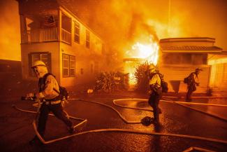 Firefighters battle the Palisades Fire as it burns during a windstorm, on the west side of Los Angeles, California, on January 7, 2025. 