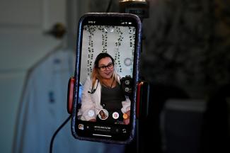 Nicole Spencer, who has postural orthostatic tachycardia syndrome, makes a video for her Instagram account, where she speaks about her medical condition, in Syracuse, New York, on May 8, 2022. 