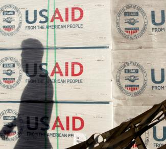 The shadow of a Philippine Army personnel is cast on boxes of relief items from USAID for the victims of super typhoon Haiyan, at Villamor Air Base, in Manila, Philippines, on November 13, 2013. 