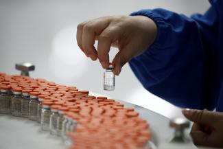 A worker performs a quality check in the packaging facility of Chinese vaccine maker Sinovac Biotech, in Beijing, China, on September 24, 2020. 