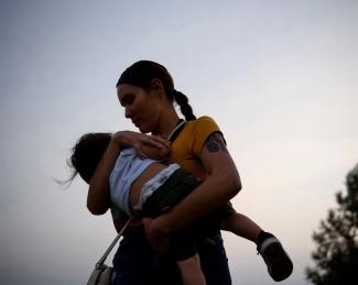 A mother holds her child, at the Fort Wagner Casino and Hotel, on the Yankton Indian Reservation, in South Dakota, on September 9, 2021.
