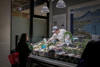 A woman shops for fish at a store, in New York City, on April 9, 2025.