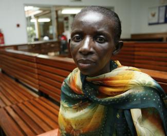 A Ugandan woman living with HIV/AIDS waits to receive antiretroviral drugs from the Infectious Disease Institute, in Kampala, Uganda, on November 30, 2006. 