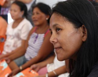 Women listen during a lecture on the prevention of gender-based violence by a United Nations Population Fund volunteer in Tacloban city, Philippines, on December 14, 2013. 
