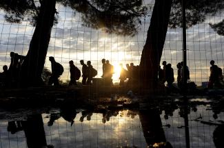 Syrian refugees walk towards Greece's border with Macedonia, near the Greek village of Idomeni, on September 14, 2015.