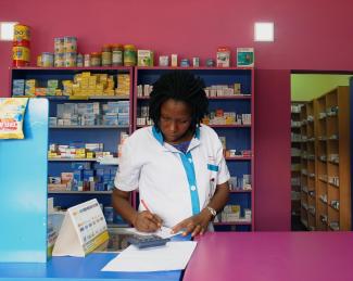 A vendor writes as she stands in a legal pharmacy, in Abidjan, Ivory Coast, on October 16, 2018. Picture taken October 16, 2018.