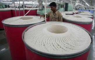 An employee works inside the Century Textiles and Industries Ltd textile mill in Gujarat, India, on October 22, 2009. 