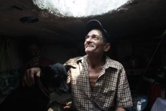 Miguel Restrepo, 62, a former drug addict, looks up from his sewer home in Medellin, Colombia, on December 4, 2012.