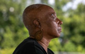 Veronica Jones, a survivor of aggressive breast cancer walks her neighborhood in Convent, Louisiana, Thursday June 26, 2025.