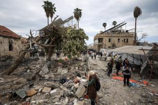 Palestinians inspect the damage after two Israeli missiles hit a building inside the Al-Ahli Arab Baptist Hospital, in the Gaza Strip, on April 13, 2025.