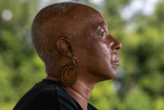 Veronica Jones, a survivor of aggressive breast cancer walks her neighborhood, in Convent, Louisiana, on June 26, 2025.