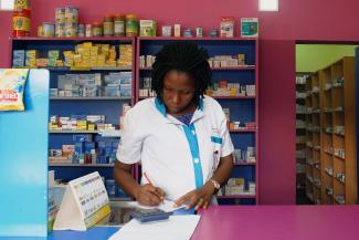 A vendor writes as she stands in a legal pharmacy, in Abidjan, Ivory Coast, on October 16, 2018. REUTERS/Luc Gnago