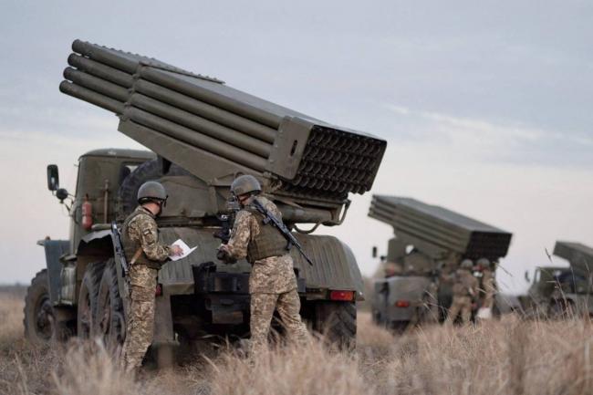 Service members of the Ukrainian Armed Forces gather near BM-21 "Grad" multiple rocket launchers during tactical military exercises at a shooting range in Kherson, Ukraine, on January 19, 2022