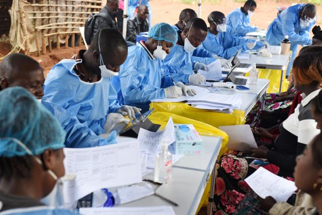 Congolese health workers register people before they are vaccinated against ebola.
