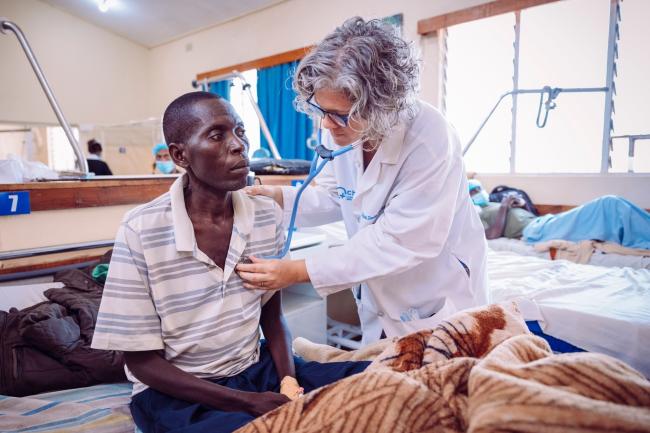 Dr. Stuebing examining a patient who came in for vomiting blood. 