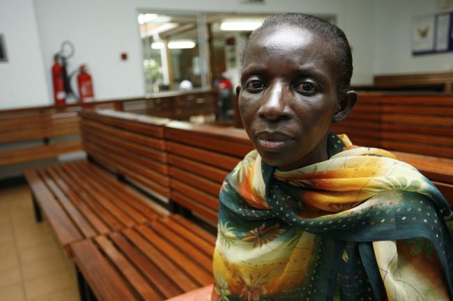 A Ugandan woman living with HIV/AIDS waits to receive antiretroviral drugs from the Infectious Disease Institute, in Kampala, Uganda, on November 30, 2006.